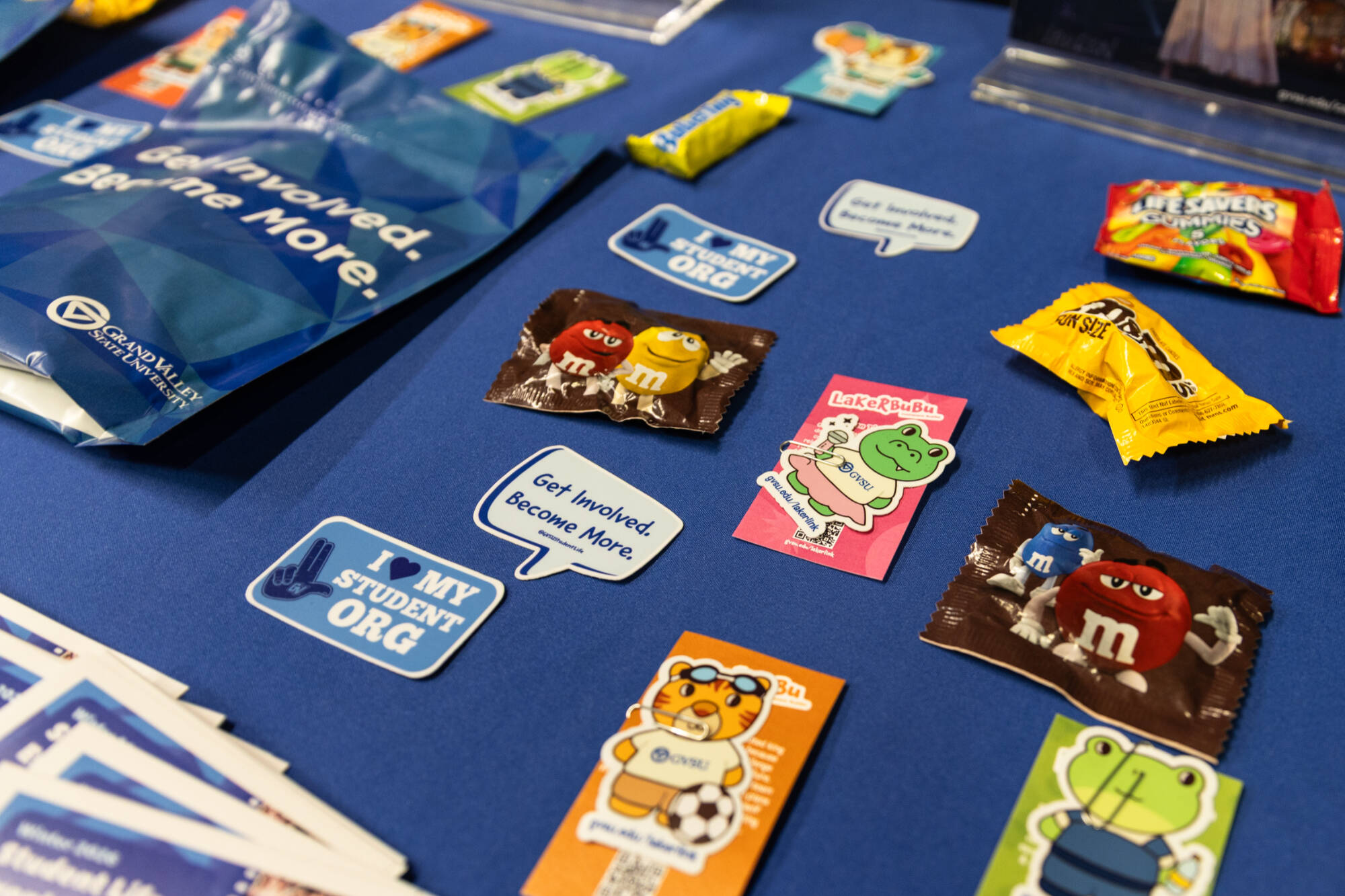 Assorted candy and GVSU stickers on a table